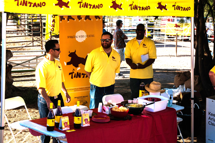 A group of men standing around a table.