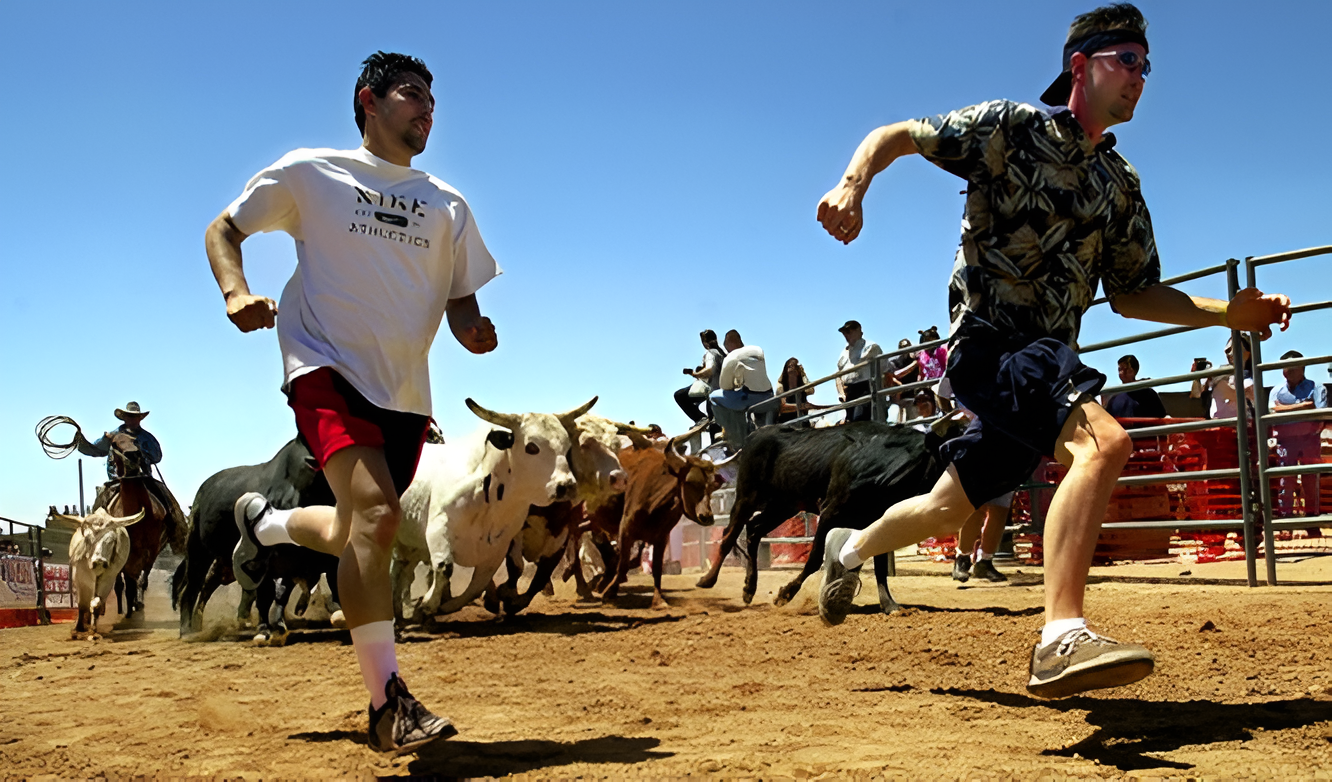 A group of men running around in the dirt.