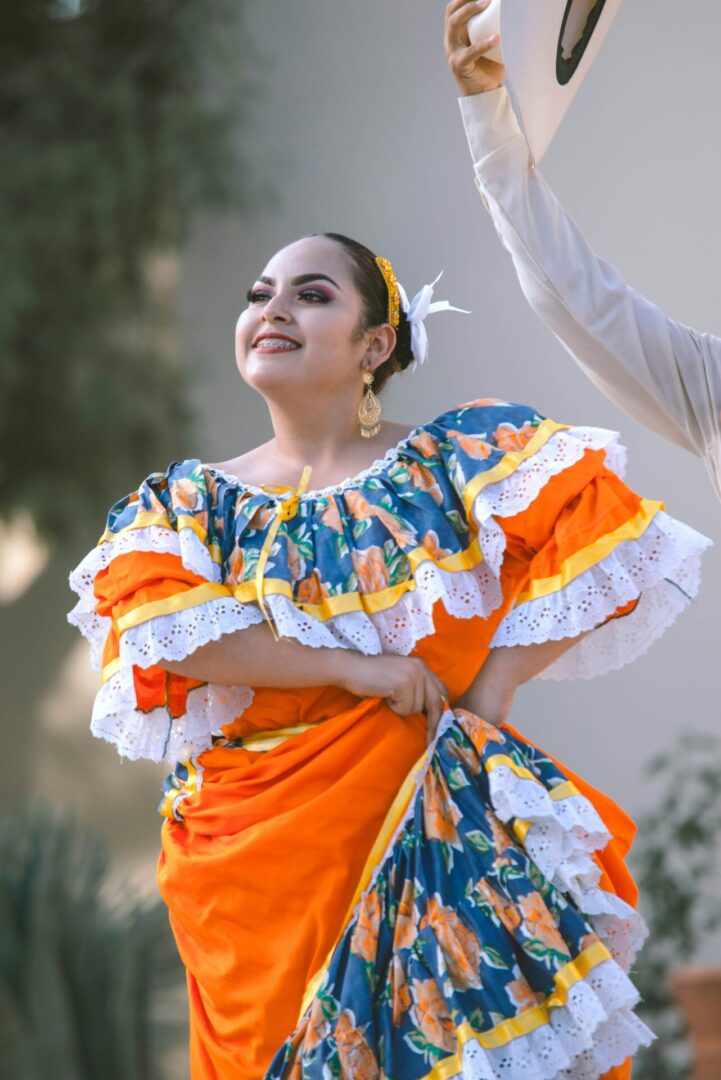 A woman in an orange and blue dress