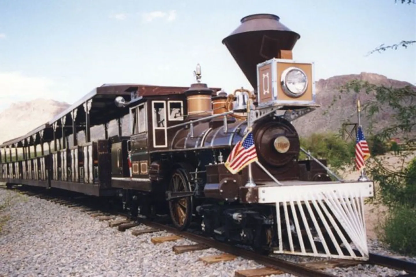 A train with an american flag on the front of it.