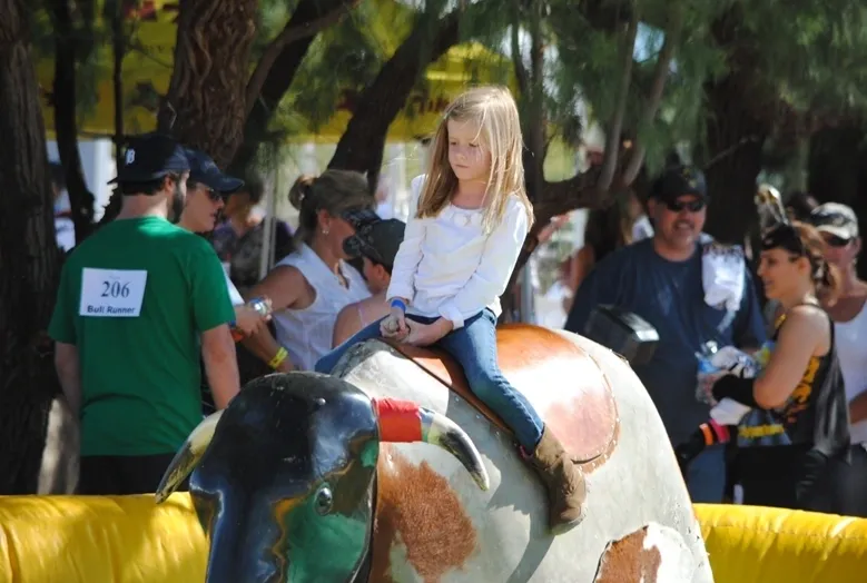 A girl sitting on the back of an elephant.