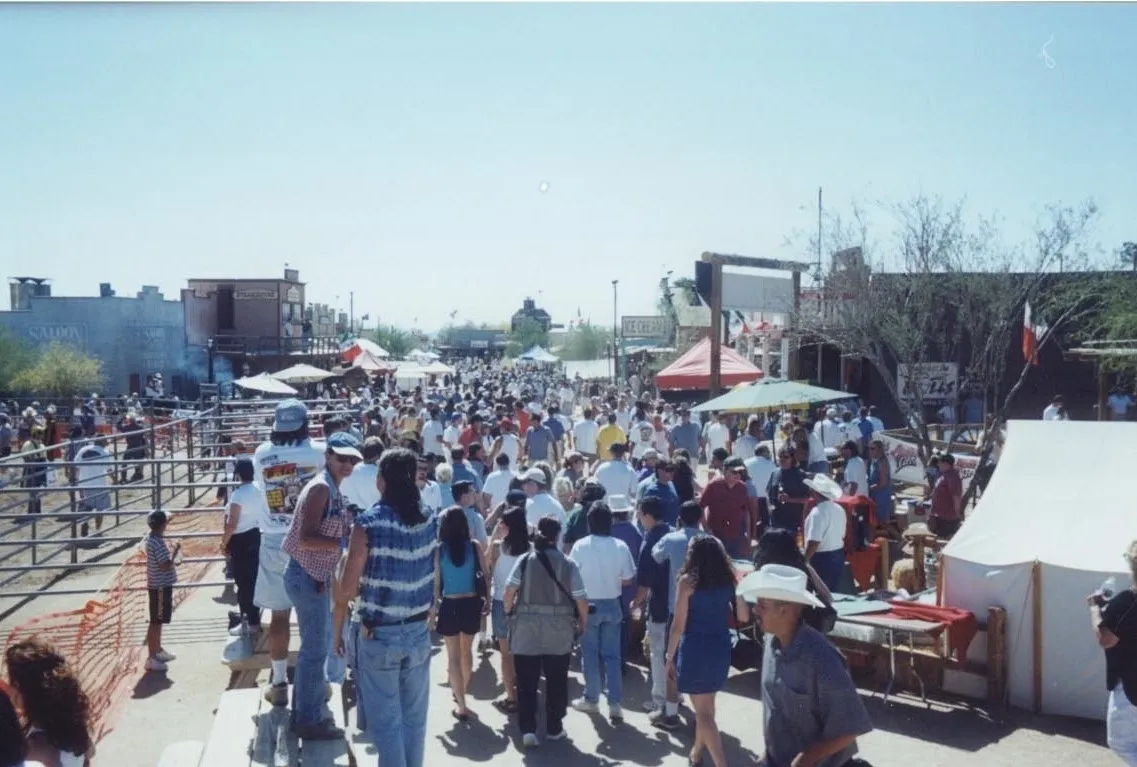 A crowd of people walking down the street.