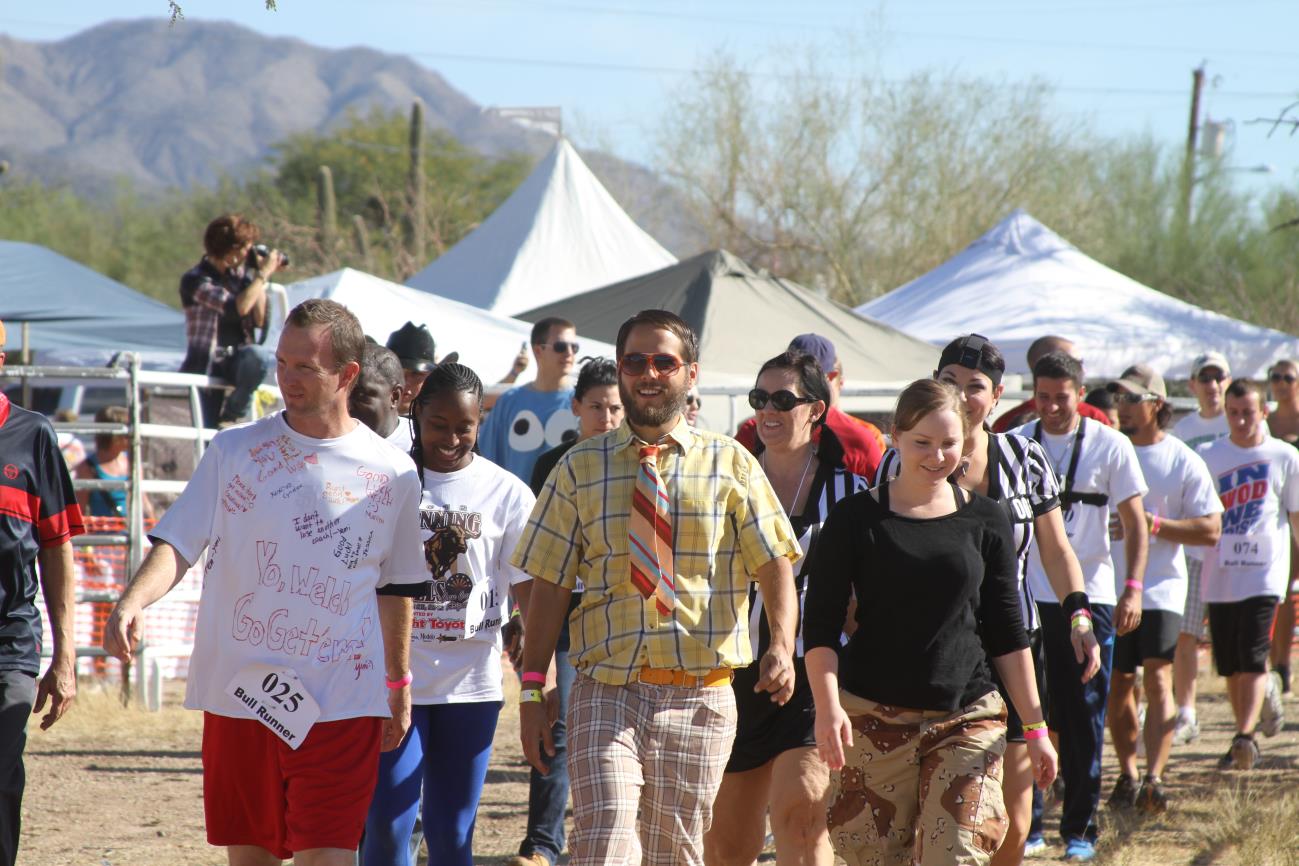 A group of people walking in the street.