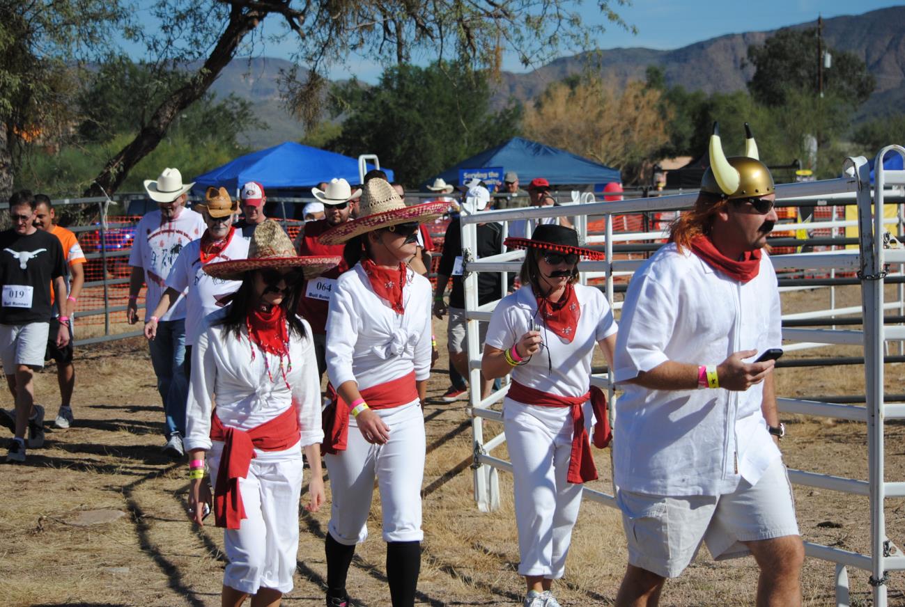 A group of people in white clothes and red bandanas.