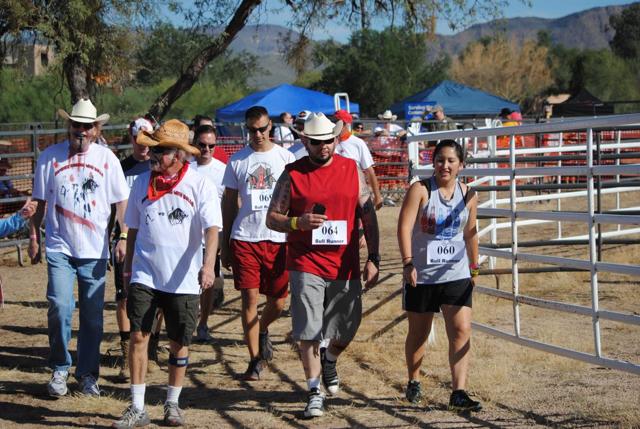 A group of people walking in the dirt.