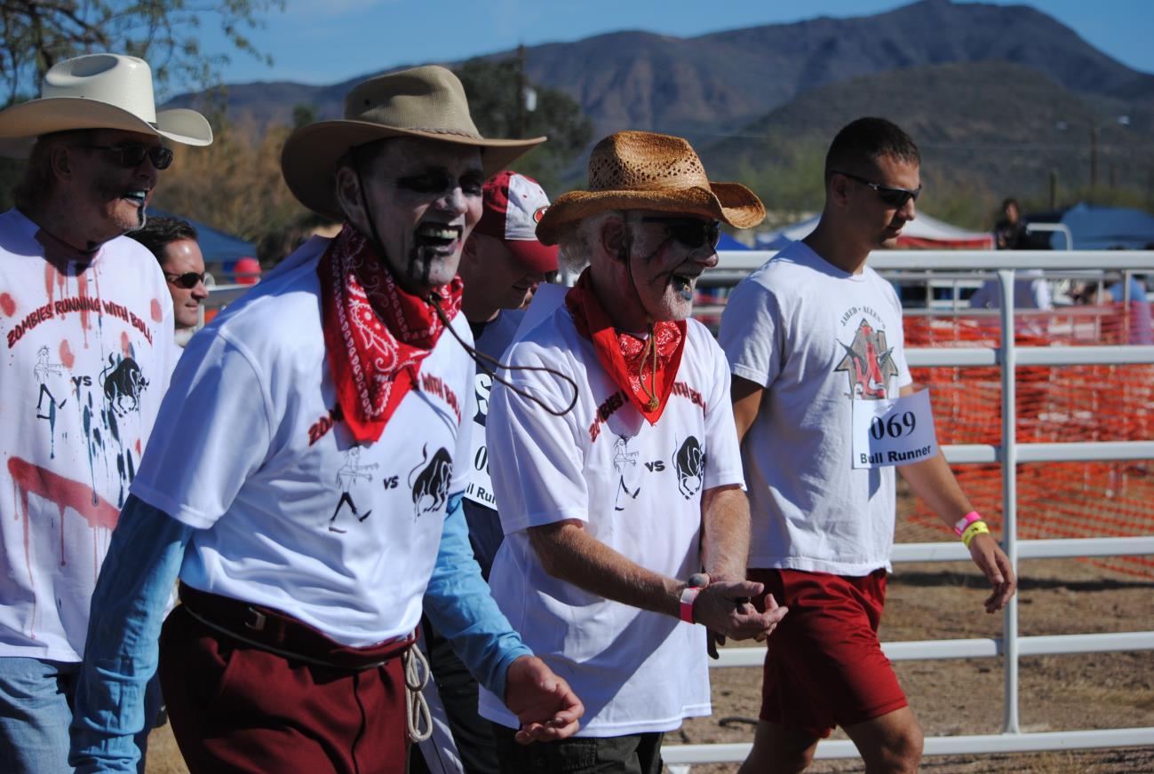 A group of people in cowboy hats and red shorts.