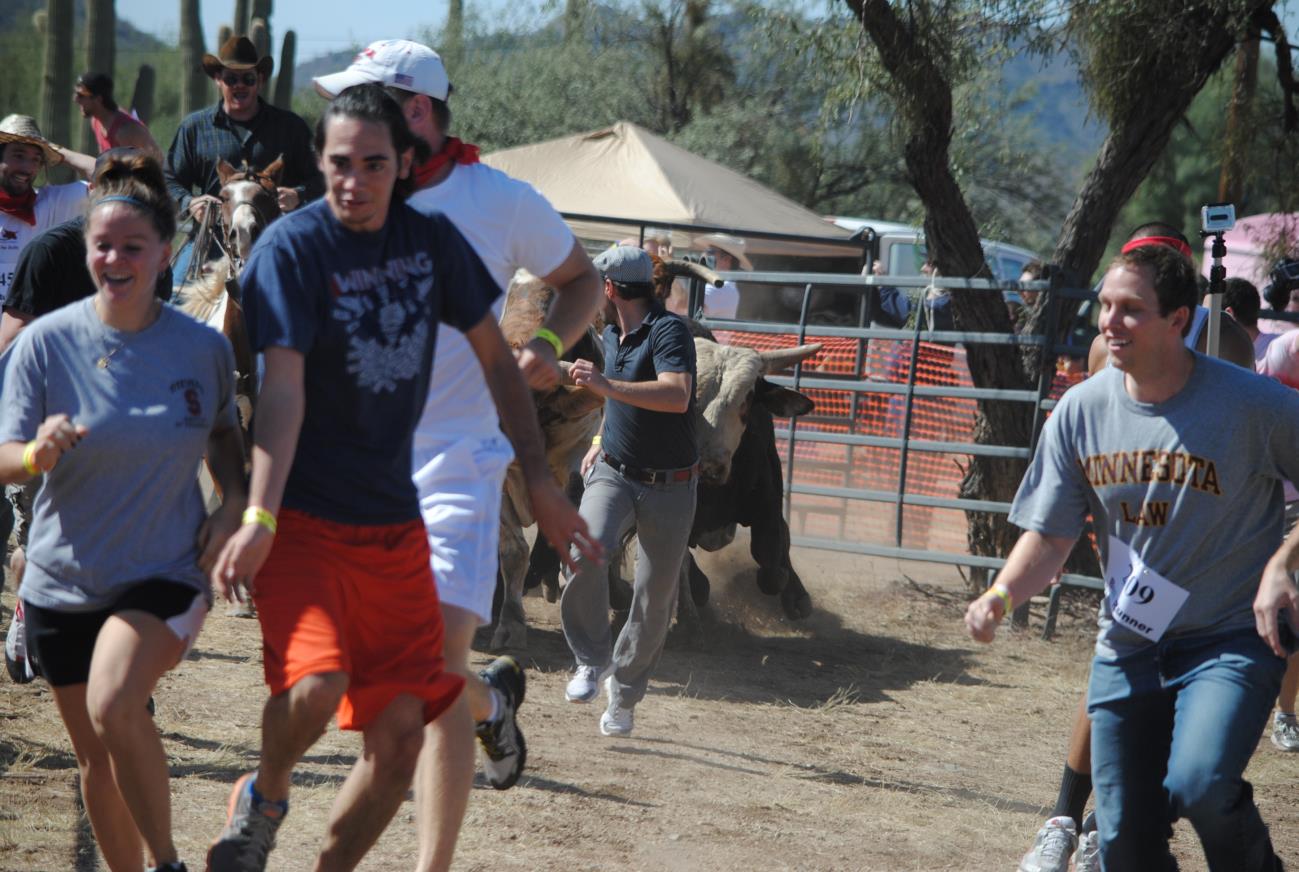 A group of people walking around in the dirt.