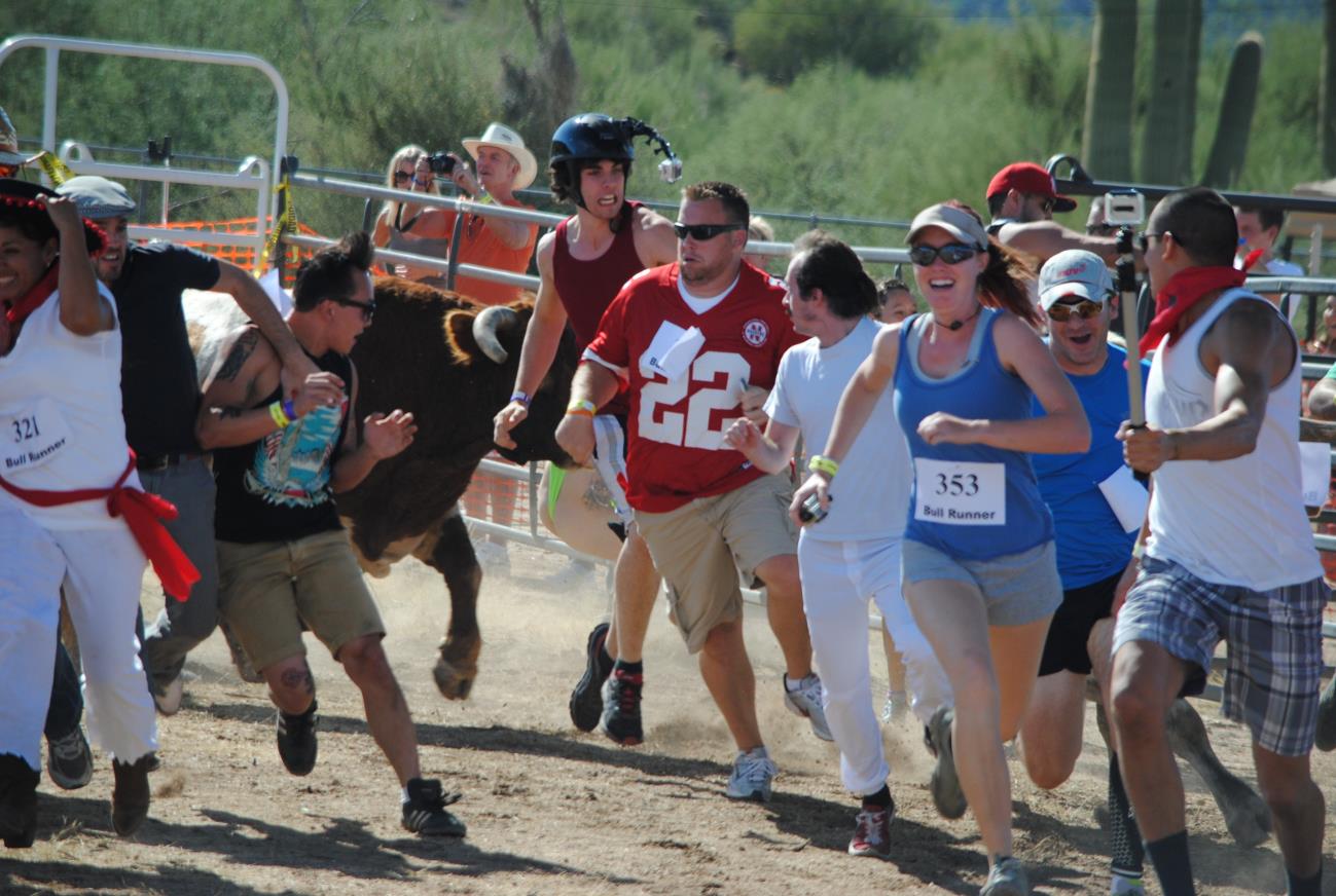 A group of people running in the dirt.