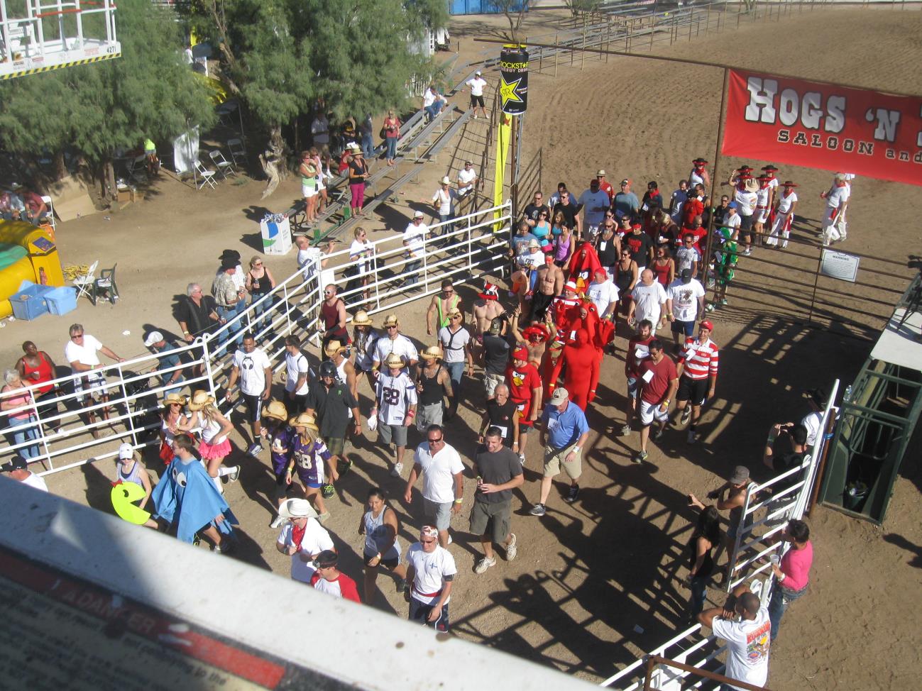 A crowd of people walking around in an arena.